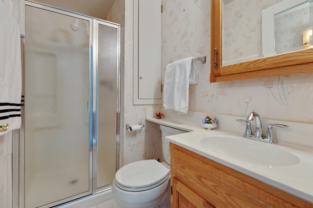 216 Center Avenue Wheeling, IL 60090 - Photo 11 of 25 a bathroom with a sink toilet and shower