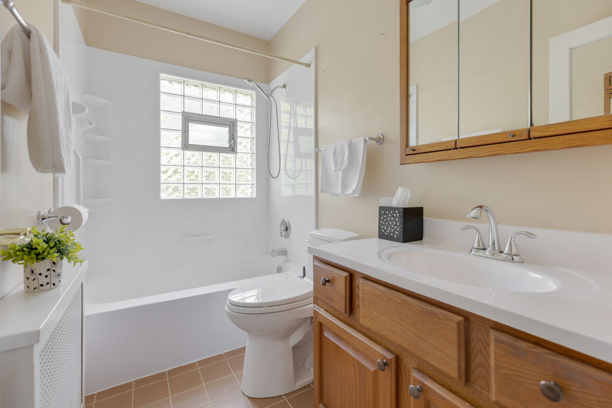 216 Center Avenue Wheeling, IL 60090 - Photo 13 of 25 a bathroom with a sink toilet and shower