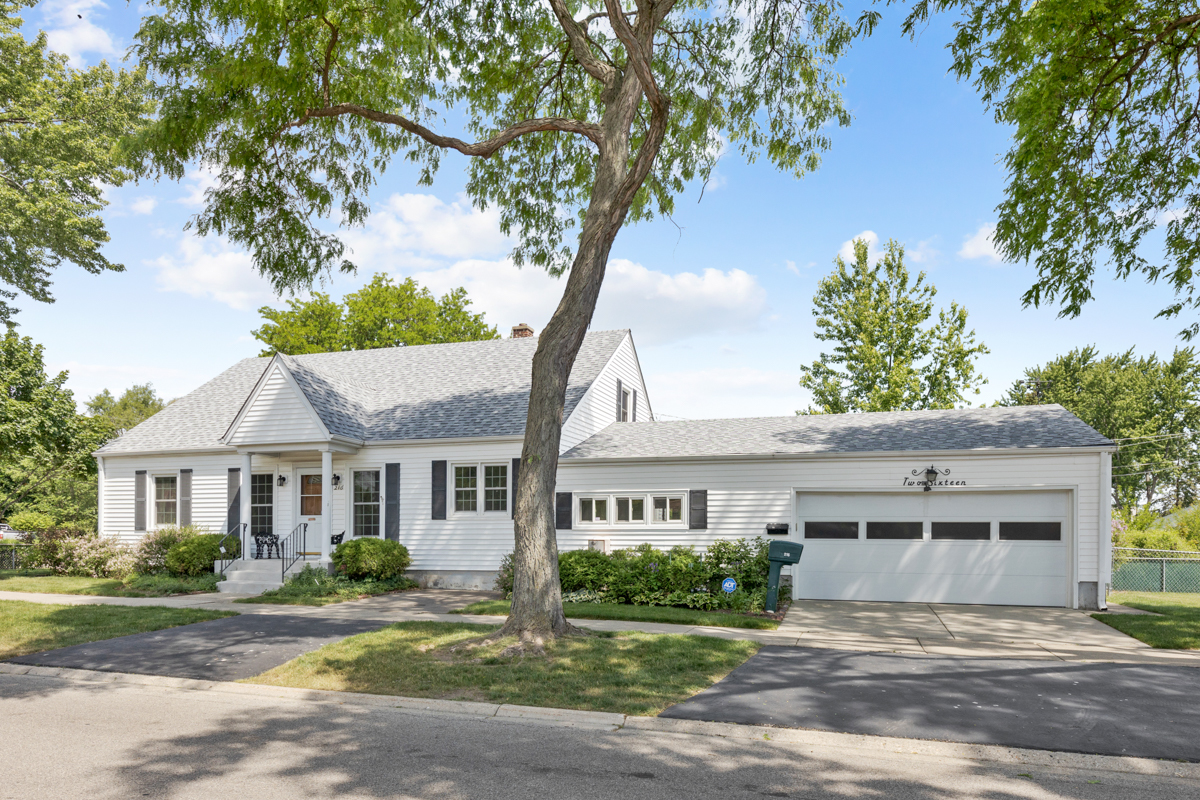 216 Center Avenue Wheeling, IL 60090 - Photo 2 of 25 a front view of a house with a garden