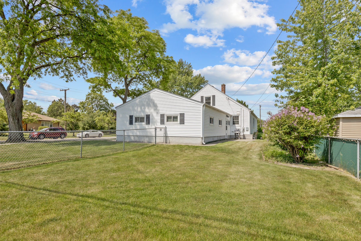 216 Center Avenue Wheeling, IL 60090 - Photo 23 of 25 a front view of a house with a garden