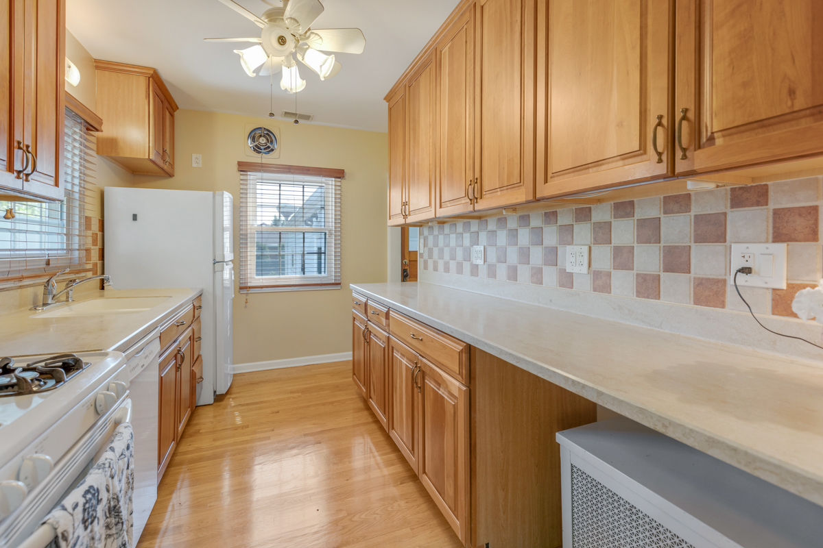 216 Center Avenue Wheeling, IL 60090 - Photo 7 of 25 a kitchen with stainless steel appliances granite countertop a sink and dishwasher a stove with wooden floor