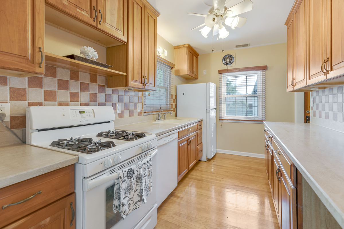 216 Center Avenue Wheeling, IL 60090 - Photo 8 of 25 a kitchen with a stove a sink and a refrigerator