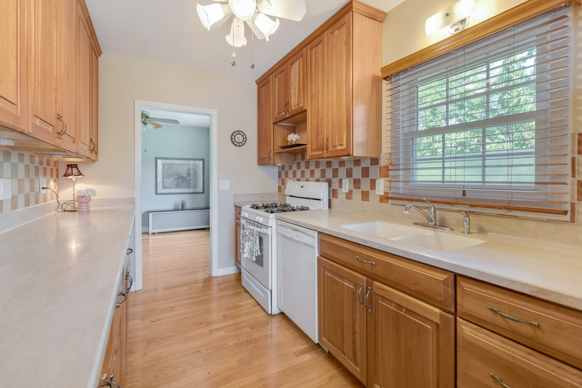 216 Center Avenue Wheeling, IL 60090 - Photo 9 of 25 a large kitchen with granite countertop a sink stainless steel appliances and cabinets