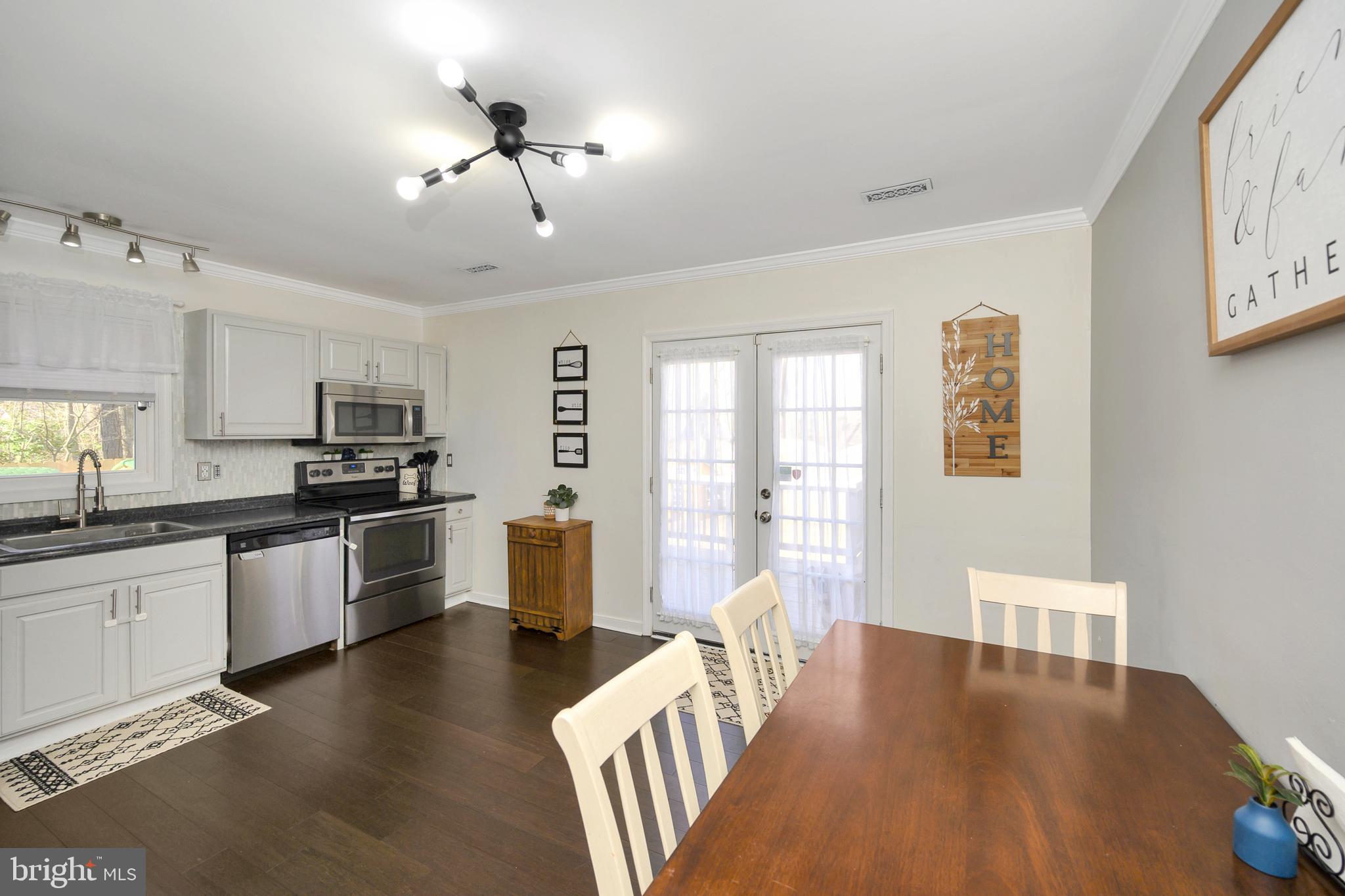 28 Benner Loop Ruther Glen, VA 22546 - Photo 25 of 54 a large kitchen with cabinets wooden floor and stainless steel appliances