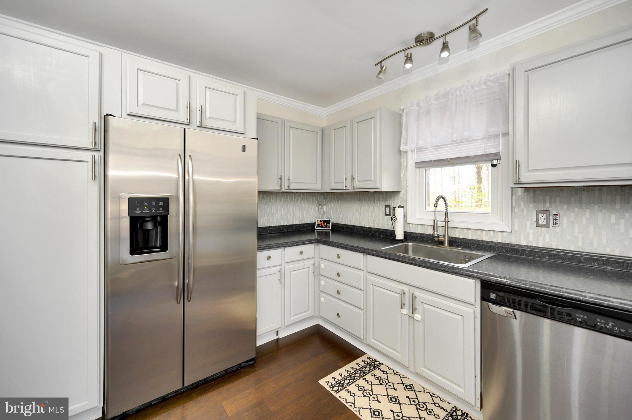 28 Benner Loop Ruther Glen, VA 22546 - Photo 27 of 54 a kitchen with stainless steel appliances a refrigerator sink and cabinets