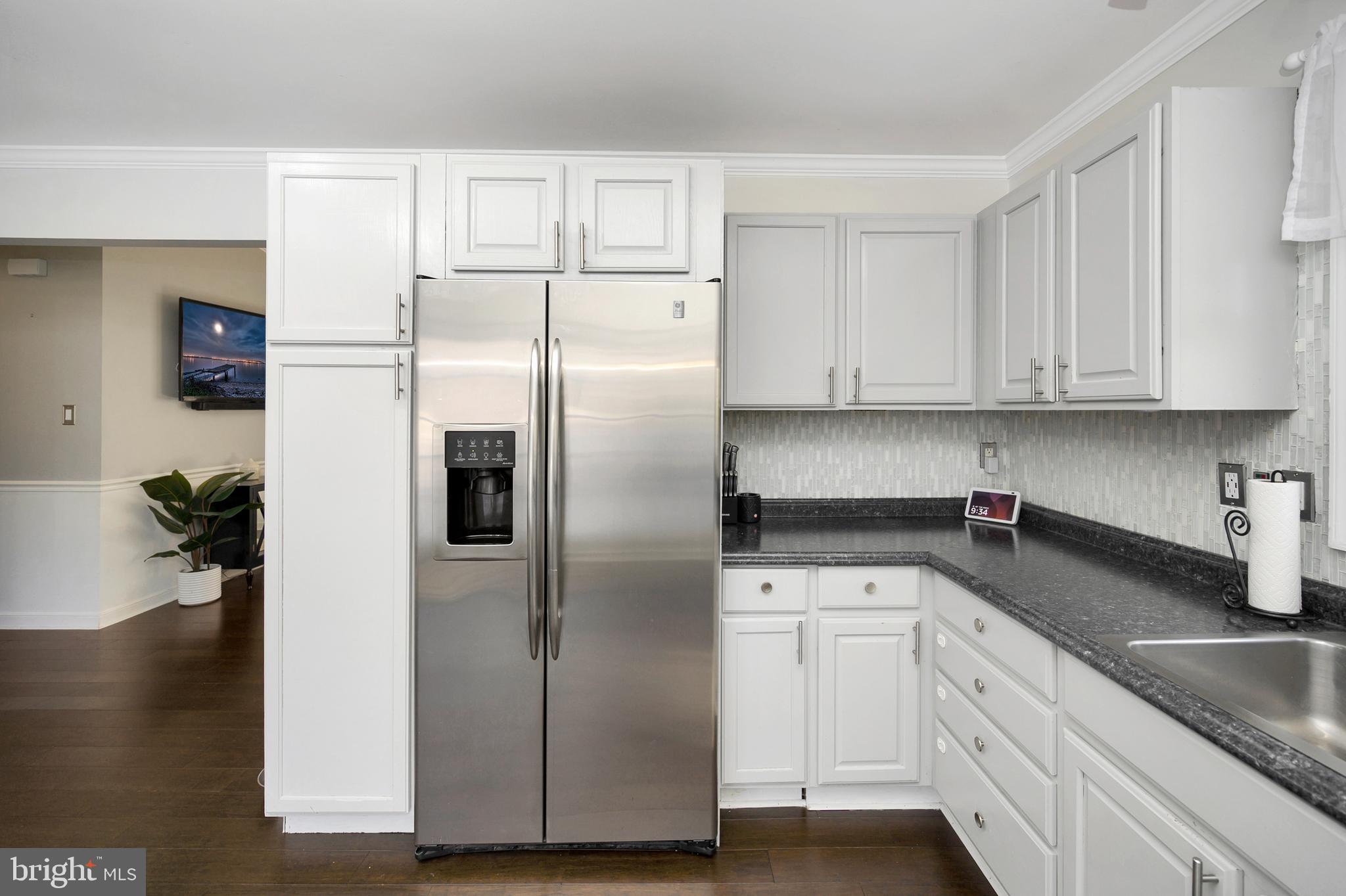 28 Benner Loop Ruther Glen, VA 22546 - Photo 29 of 54 a kitchen with granite countertop a refrigerator sink and cabinets