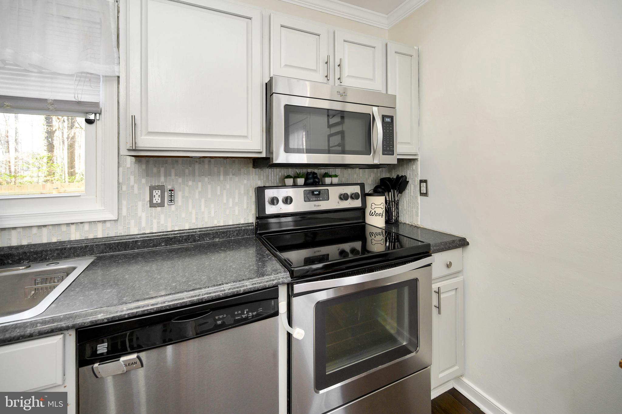 28 Benner Loop Ruther Glen, VA 22546 - Photo 33 of 54 a kitchen with a stove and a microwave