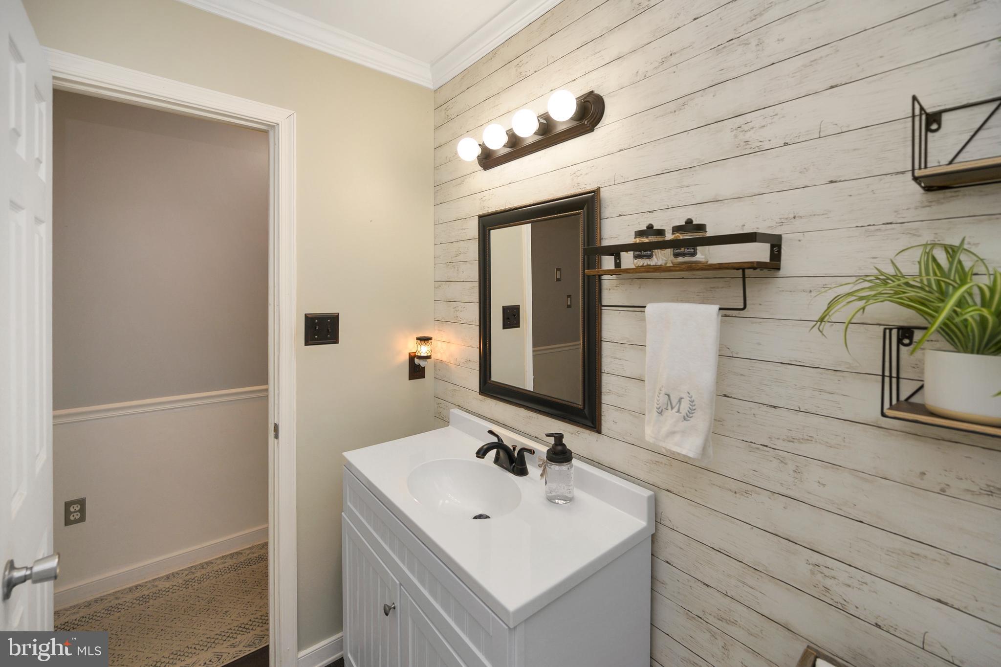 28 Benner Loop Ruther Glen, VA 22546 - Photo 39 of 54 a bathroom with a sink and a mirror