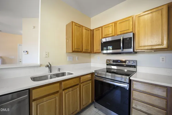 a kitchen with a sink stove and microwave
