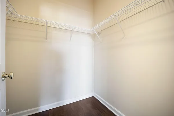 a view of a small space with wooden floor and a window