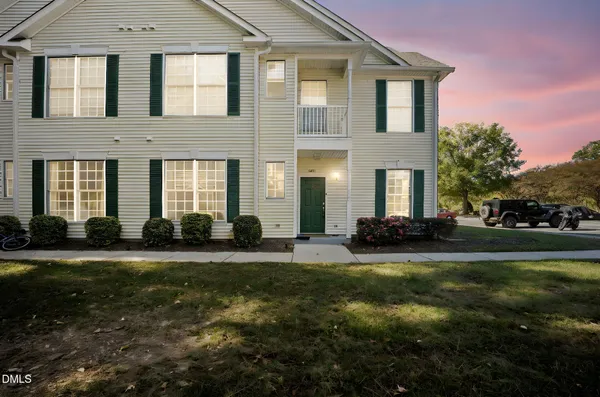 a view of a house with backyard and sitting area