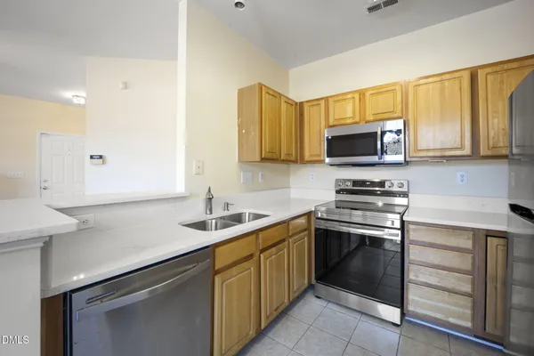a kitchen with a sink stove and microwave
