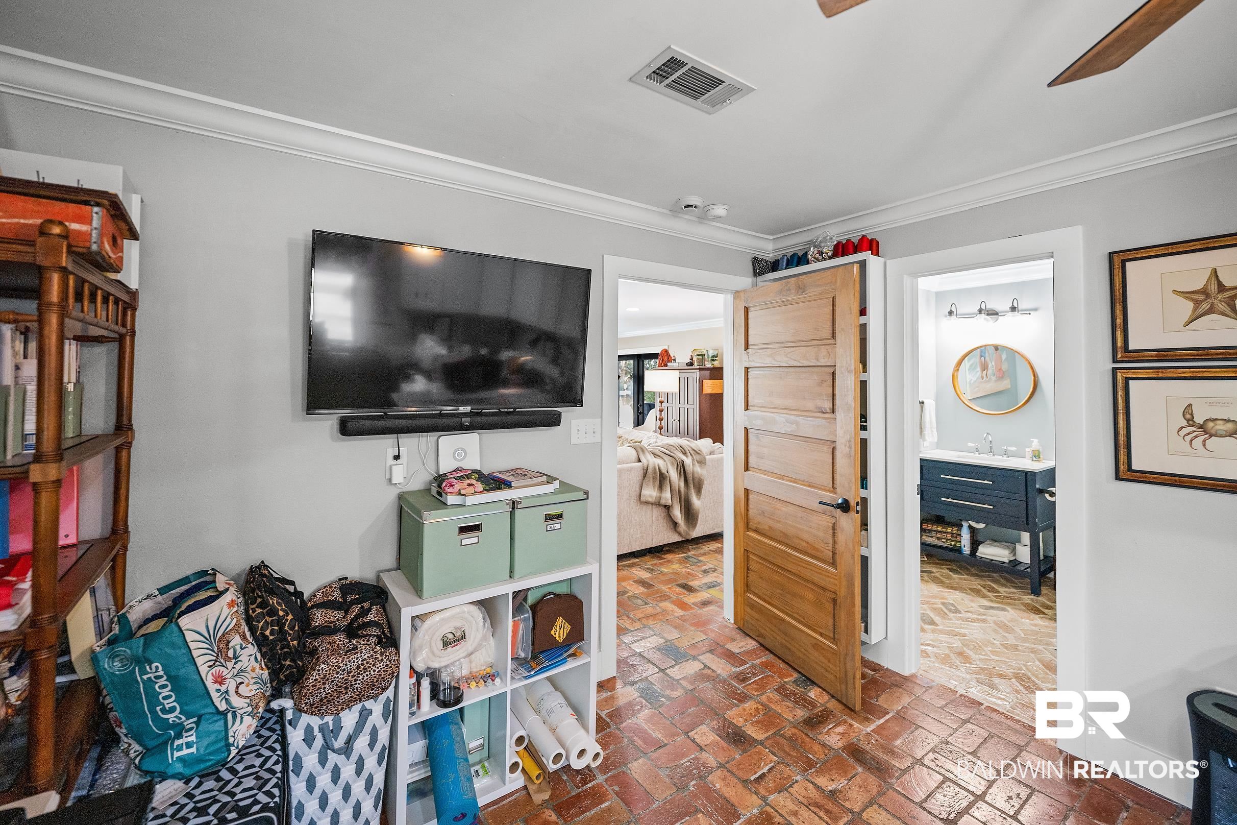 8490 Bay View Drive Foley, AL 36535 - Photo 30 of 67 Recreation room with brick floors, crown molding, and a ceiling fan