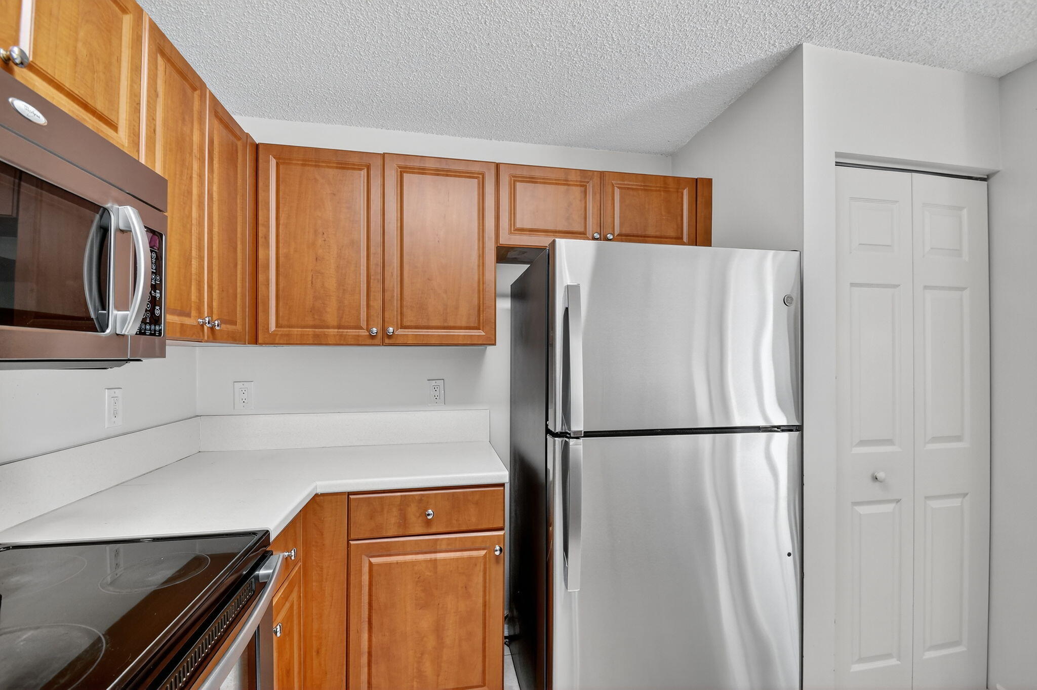 3386 Commodore Court West Palm Beach, FL 33411 - Photo 12 of 79 a white refrigerator freezer sitting in a kitchen