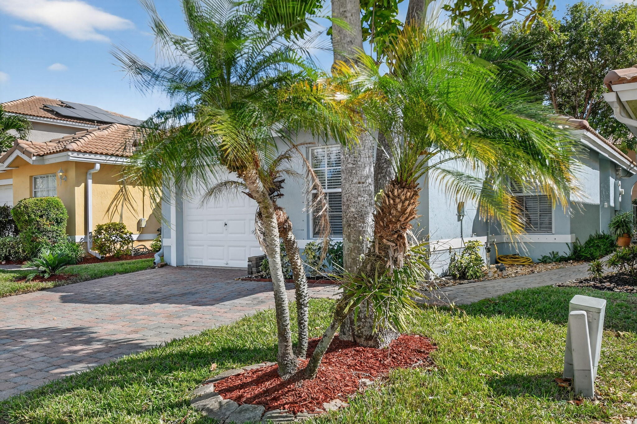 3386 Commodore Court West Palm Beach, FL 33411 - Photo 2 of 79 a front view of a house with a yard and tree