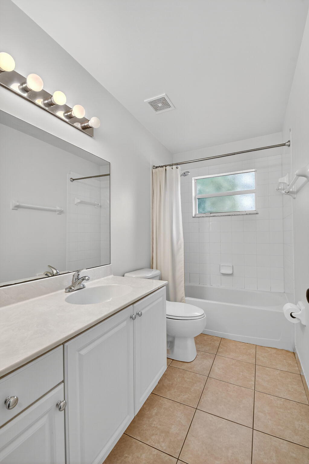 3386 Commodore Court West Palm Beach, FL 33411 - Photo 22 of 79 a bathroom with a granite countertop sink a toilet and a mirror