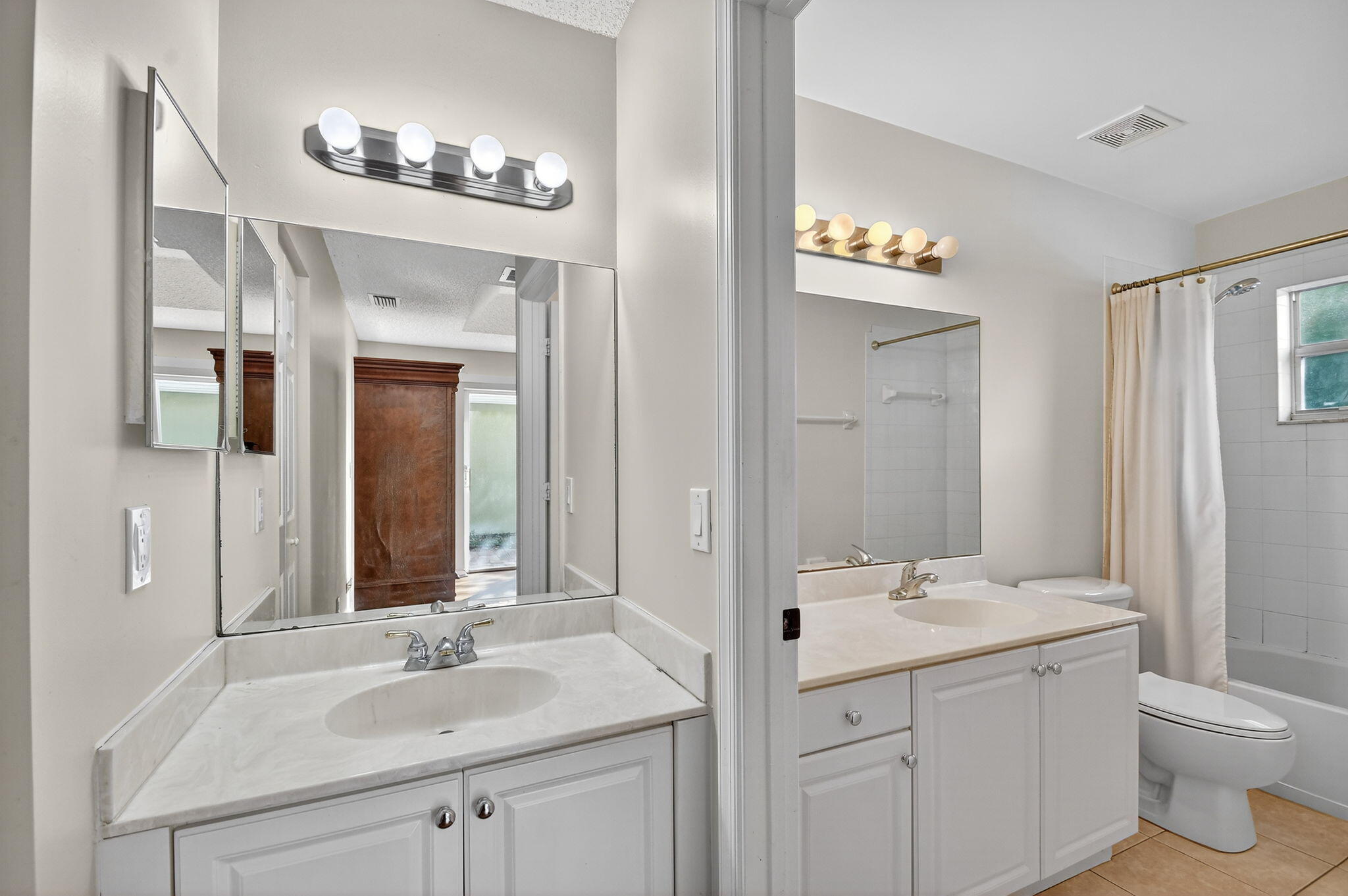3386 Commodore Court West Palm Beach, FL 33411 - Photo 23 of 79 a bathroom with a sink double vanity and a mirror