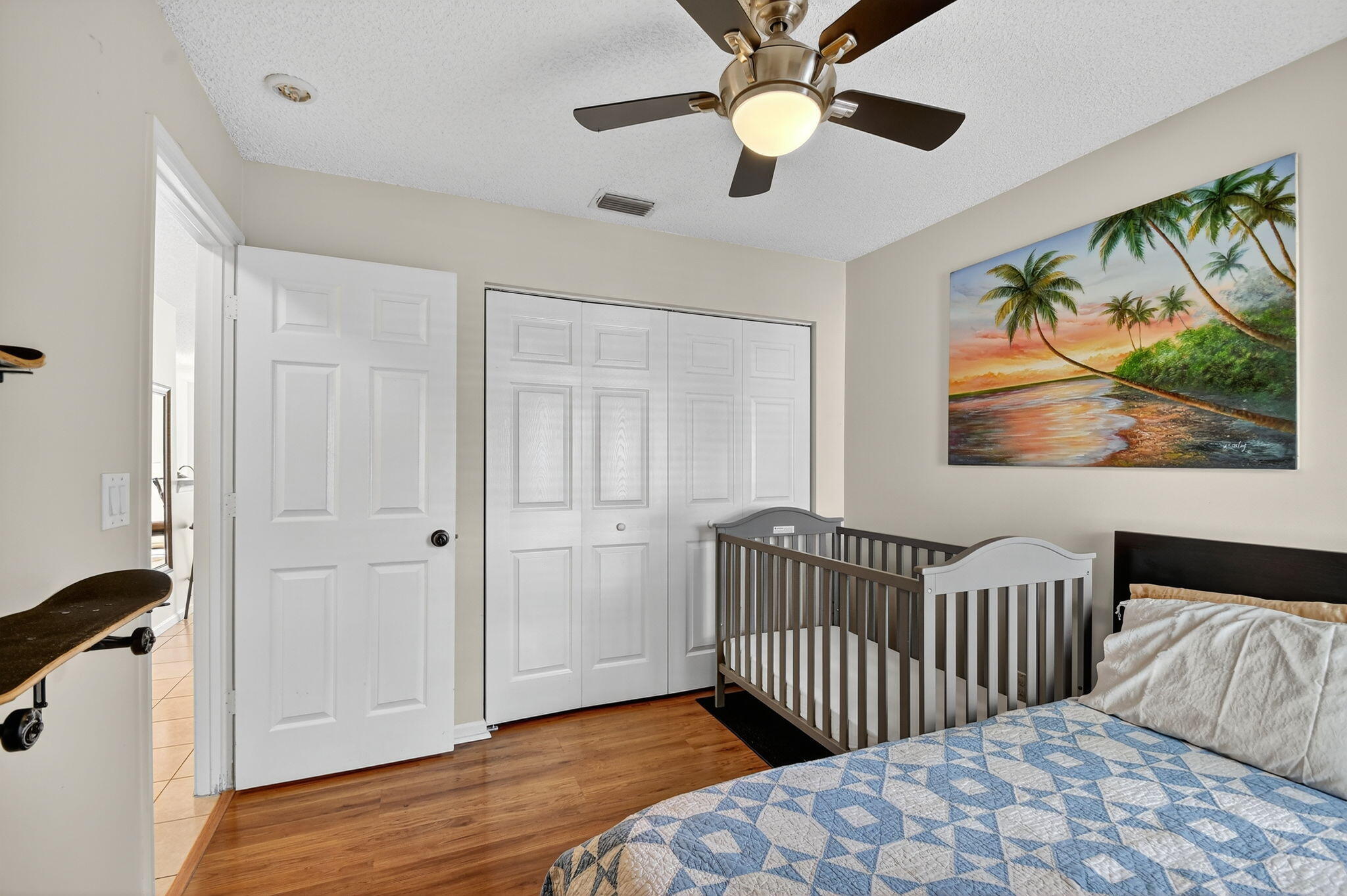3386 Commodore Court West Palm Beach, FL 33411 - Photo 26 of 79 a bedroom with a bed and a painting on the wall