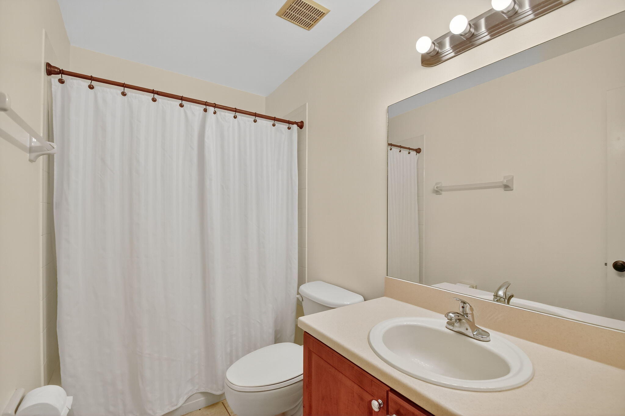 3386 Commodore Court West Palm Beach, FL 33411 - Photo 27 of 79 a bathroom with a sink toilet and a mirror