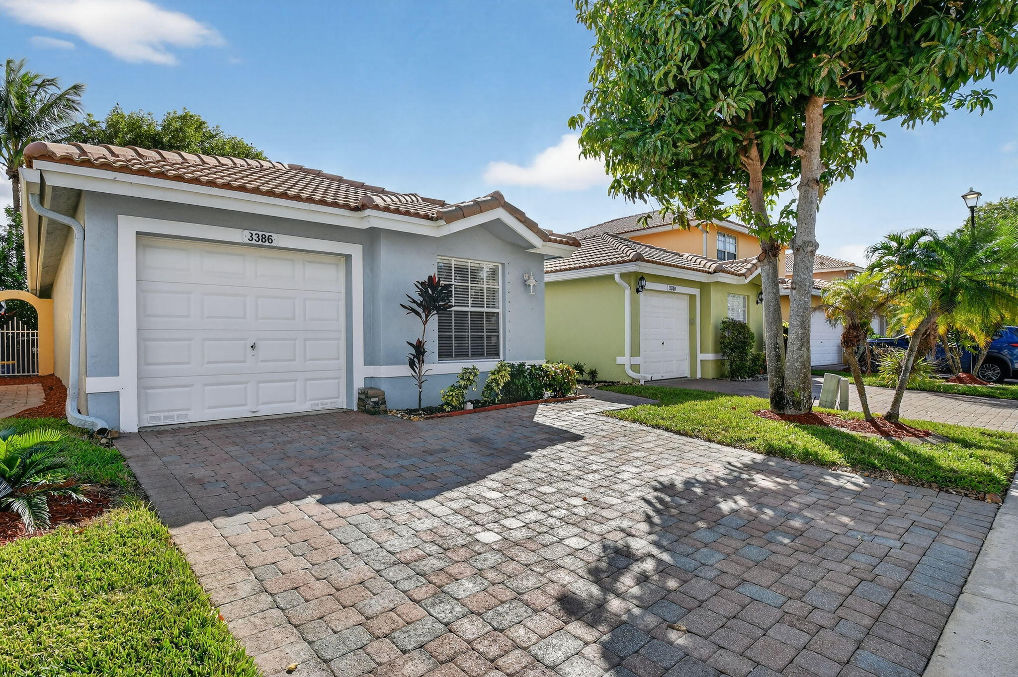 3386 Commodore Court West Palm Beach, FL 33411 - Photo 3 of 79 a front view of a house with a yard and garage
