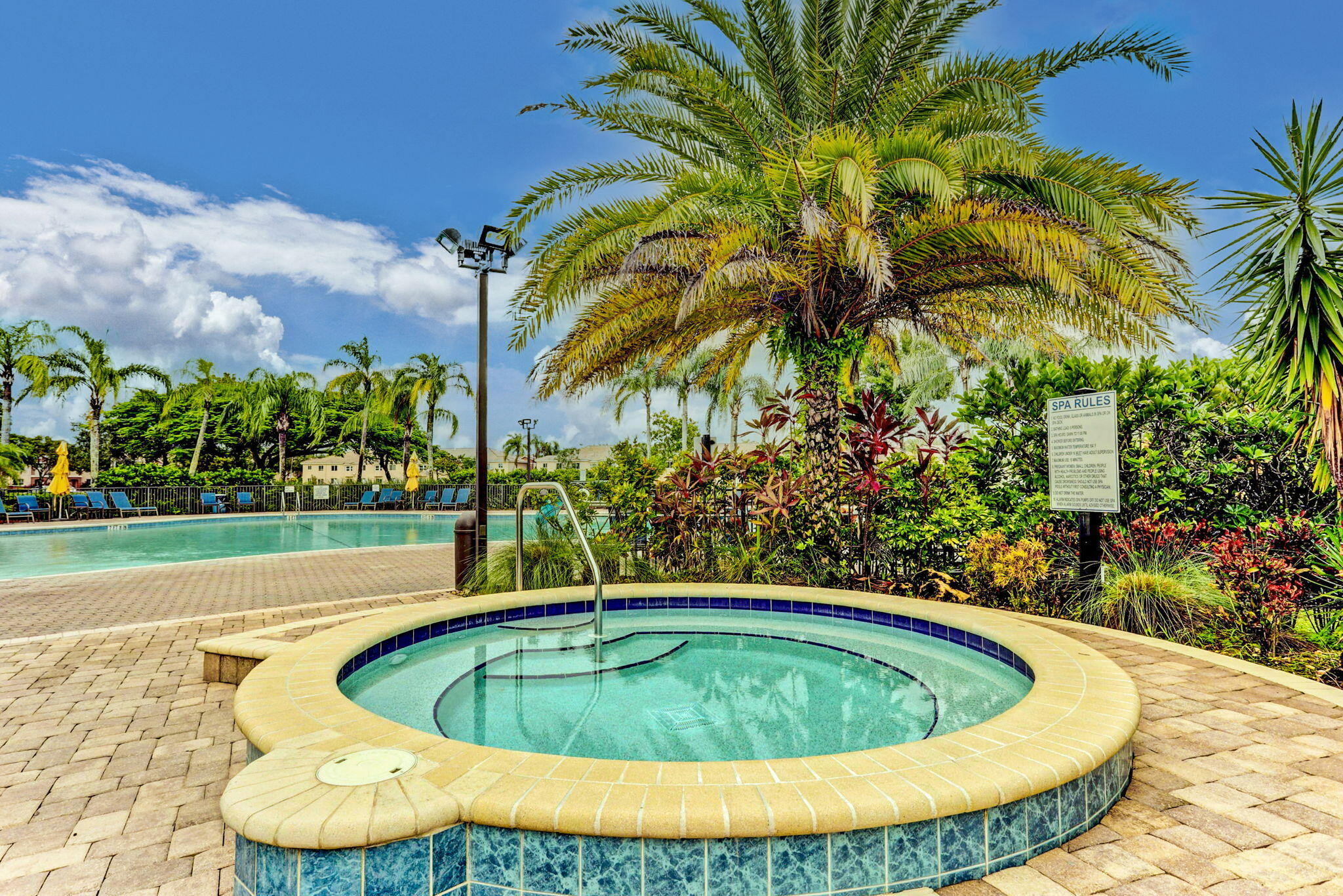 3386 Commodore Court West Palm Beach, FL 33411 - Photo 43 of 79 a view of a swimming pool with a yard and plants