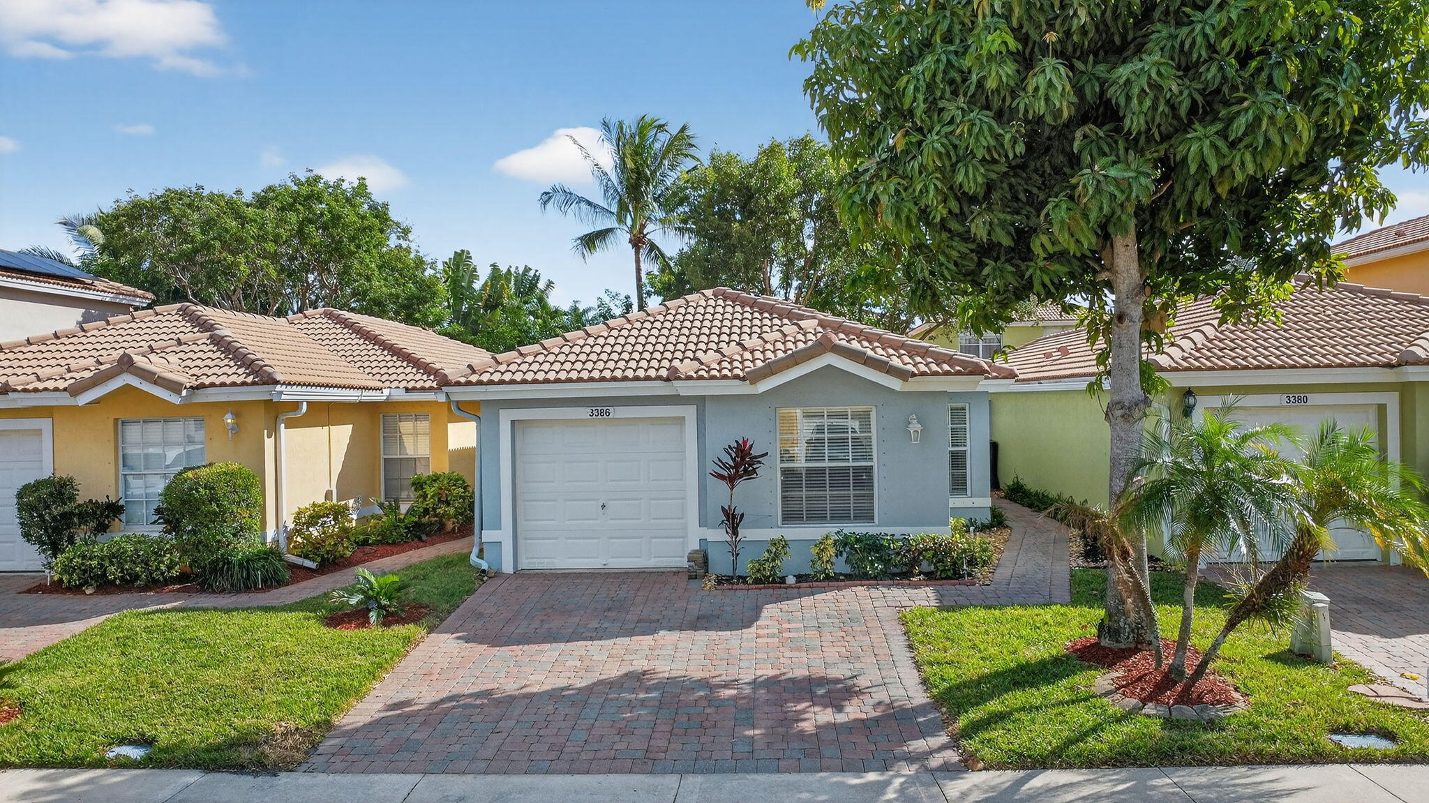 3386 Commodore Court West Palm Beach, FL 33411 - Photo 5 of 79 a front view of a house with a garden