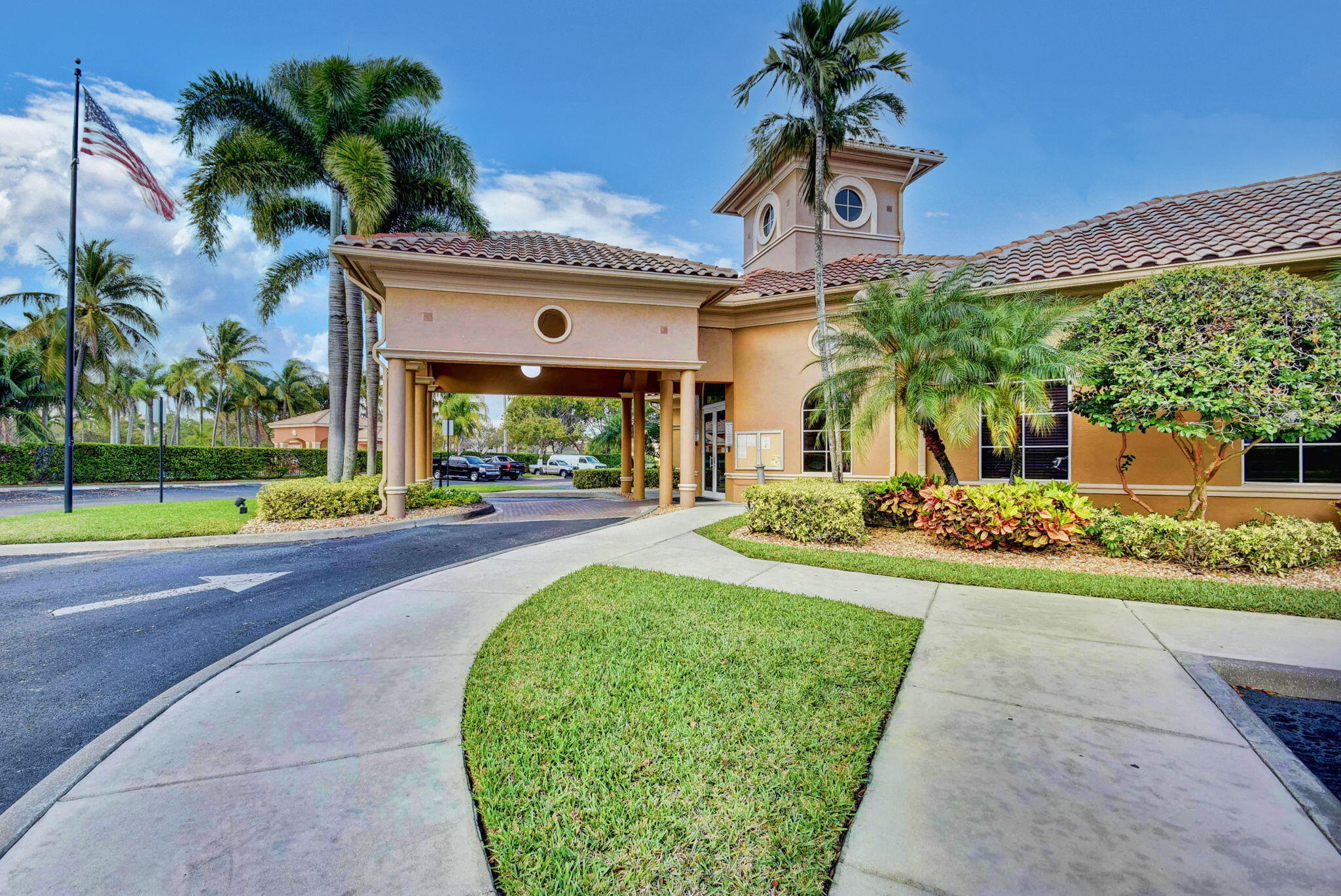 3386 Commodore Court West Palm Beach, FL 33411 - Photo 57 of 79 a front view of a house with a yard and potted plants