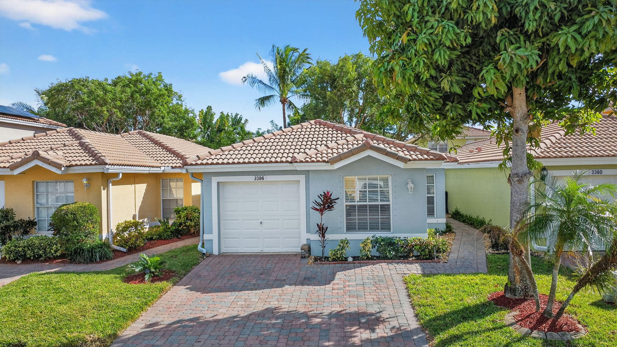 3386 Commodore Court West Palm Beach, FL 33411 - Photo 6 of 79 a front view of a house with a garden