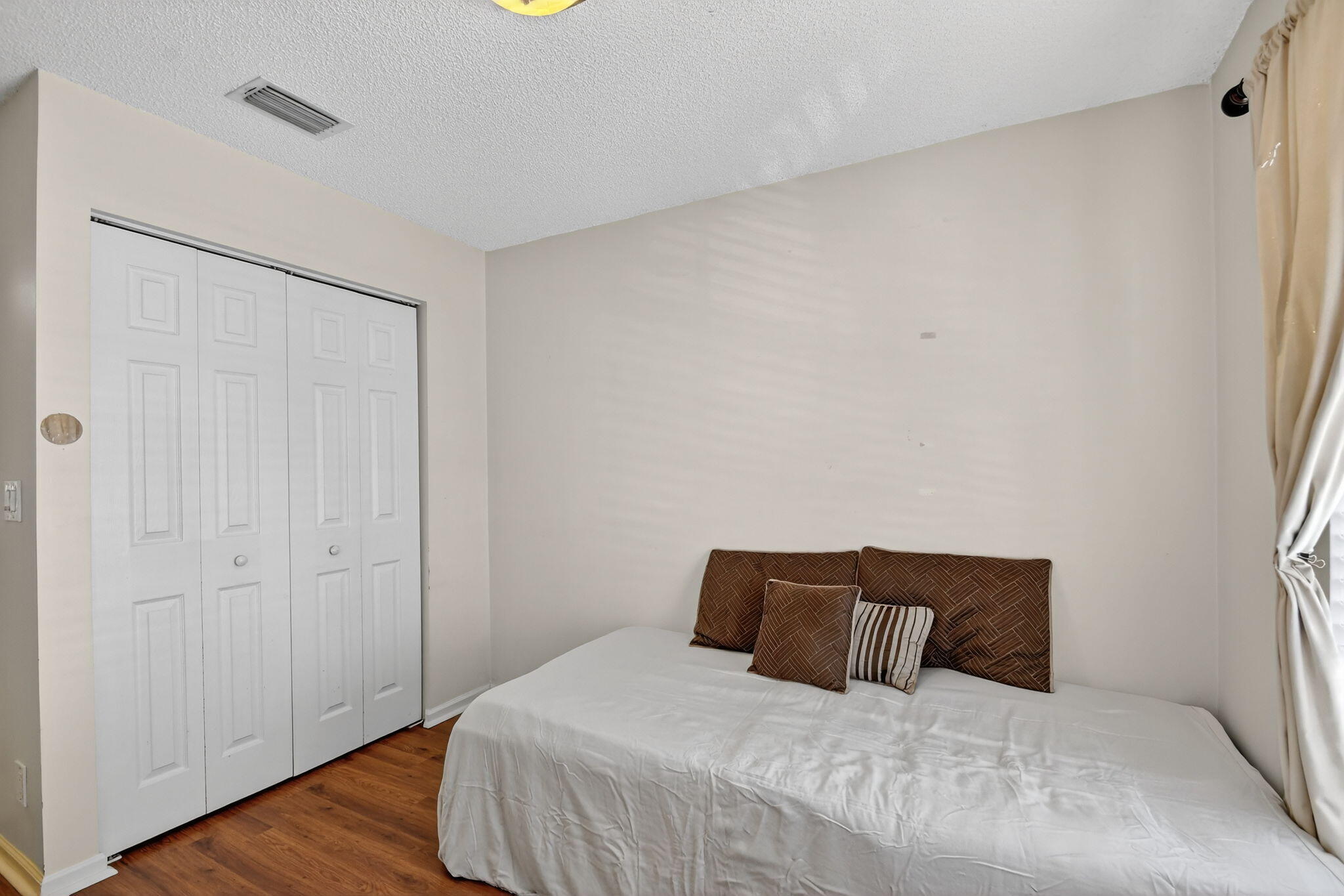 3386 Commodore Court West Palm Beach, FL 33411 - Photo 76 of 79 a bedroom with a bed and wooden floor