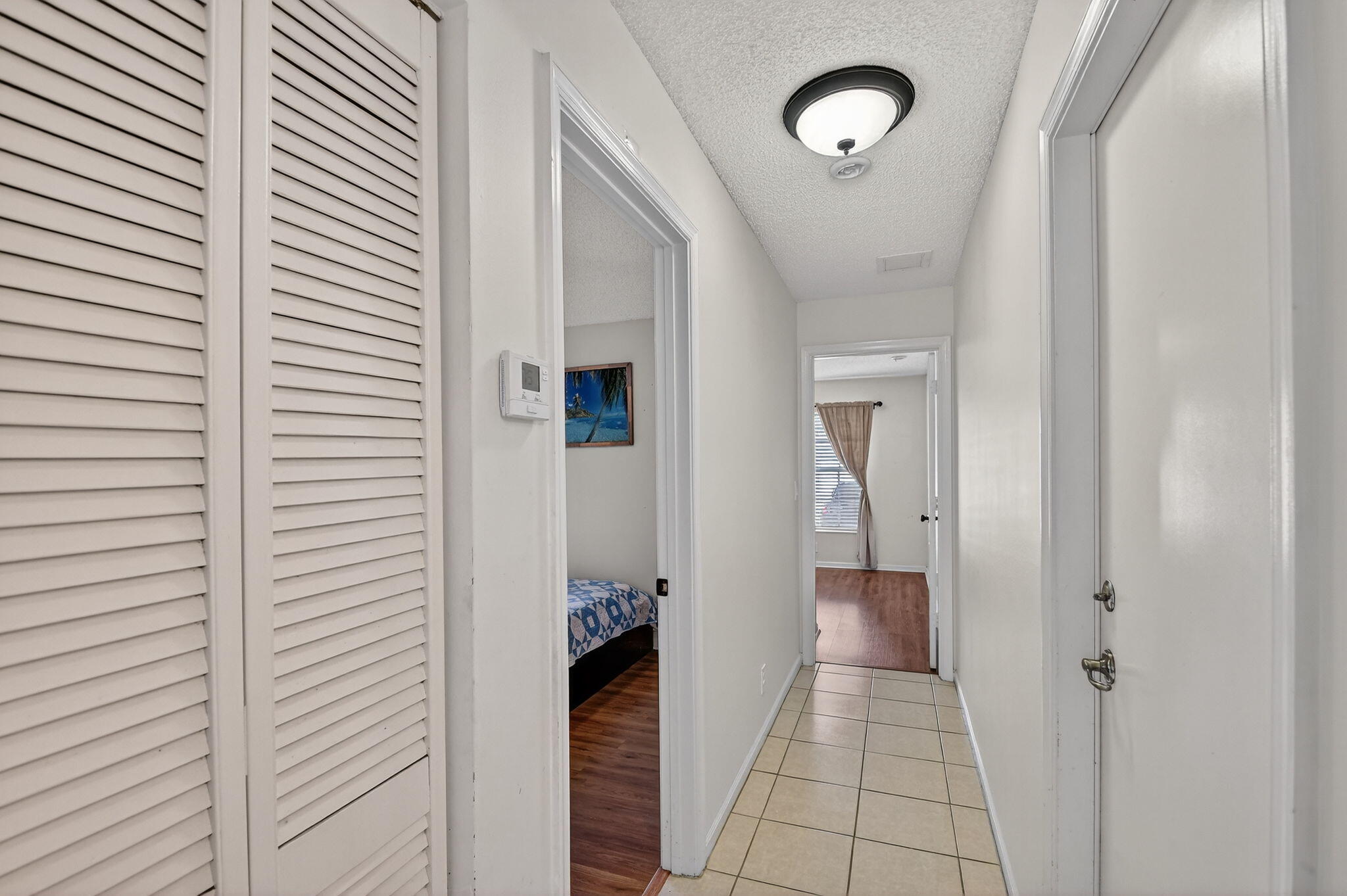 3386 Commodore Court West Palm Beach, FL 33411 - Photo 79 of 79 a view of a hallway with wooden floor windows and a bathroom