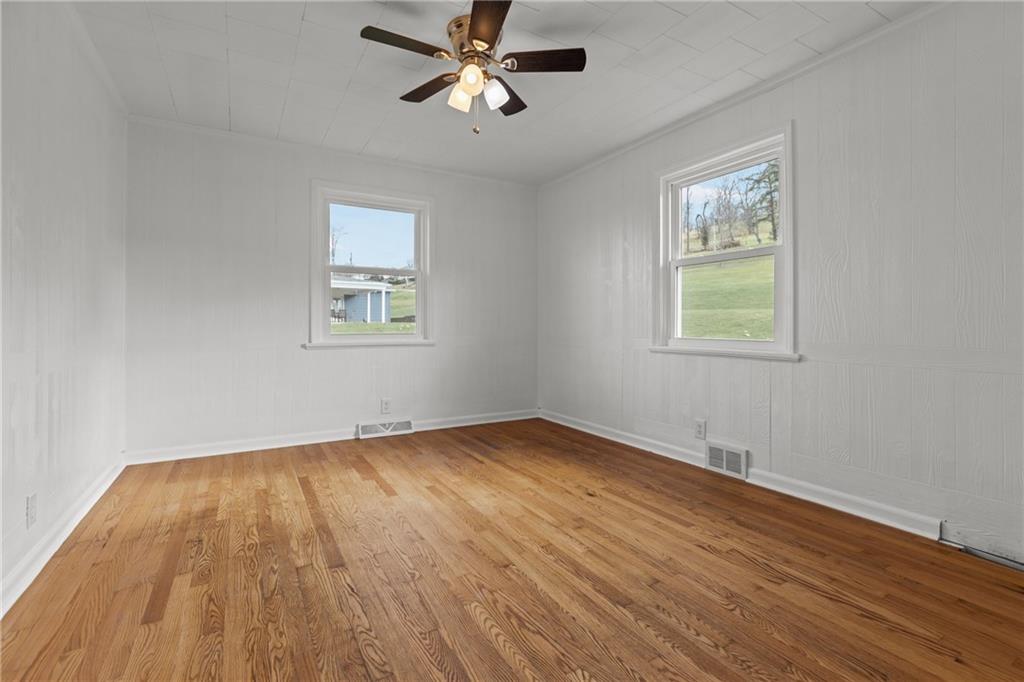 1300 Main Street Bentleyville, PA 15314 - Photo 20 of 36 a view of an empty room with wooden floor and a window