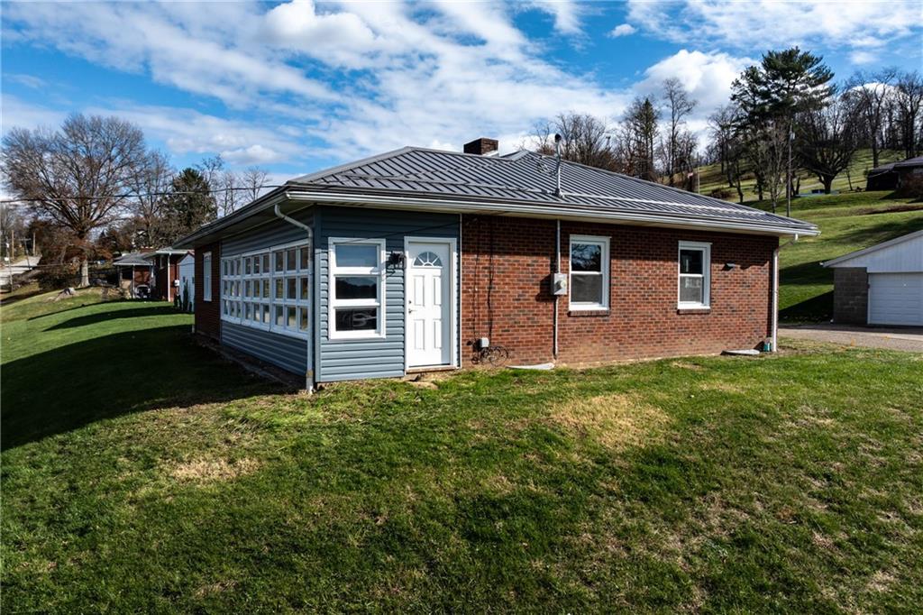 1300 Main Street Bentleyville, PA 15314 - Photo 2 of 36 a front view of a house with a garden