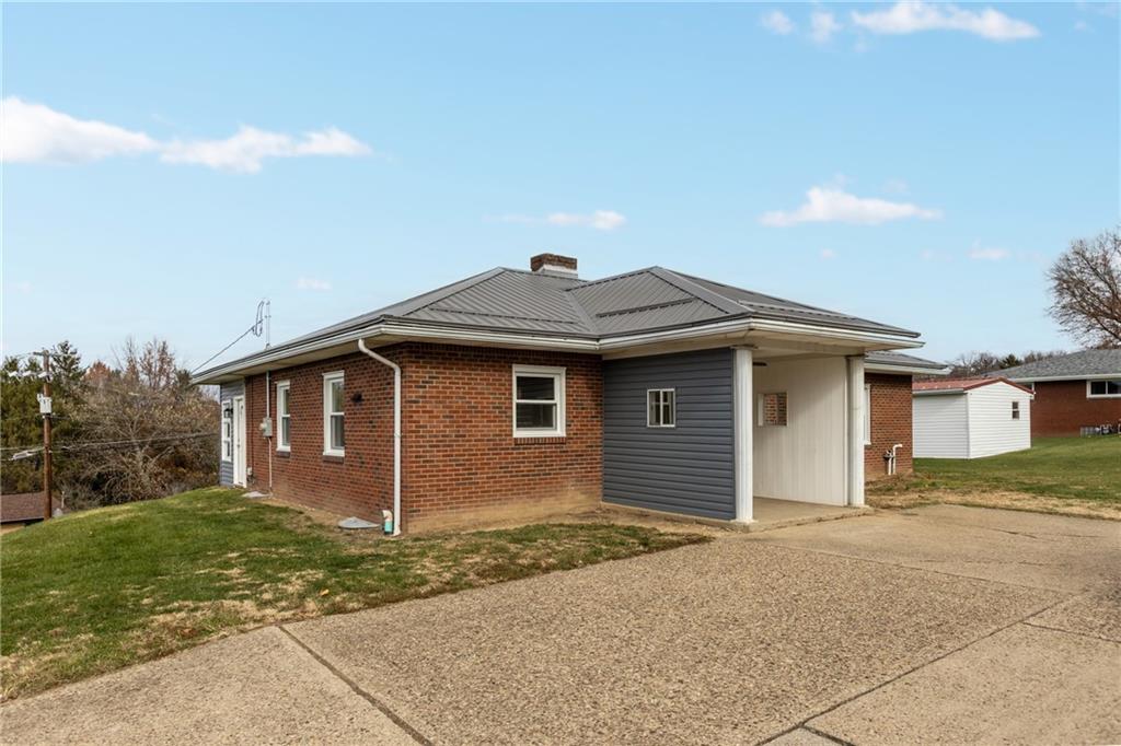 1300 Main Street Bentleyville, PA 15314 - Photo 5 of 36 a front view of a house with a yard and garage