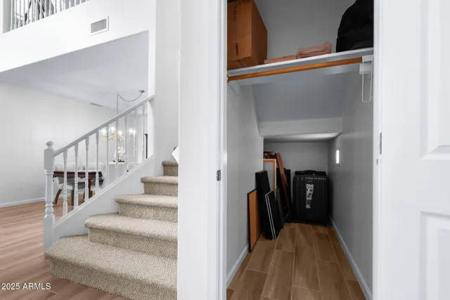 a view of a hallway with dining room and stairs