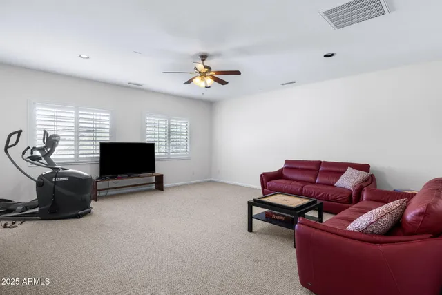 a view of a livingroom with furniture and staircase