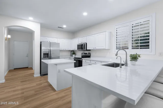 a kitchen with a refrigerator and a sink