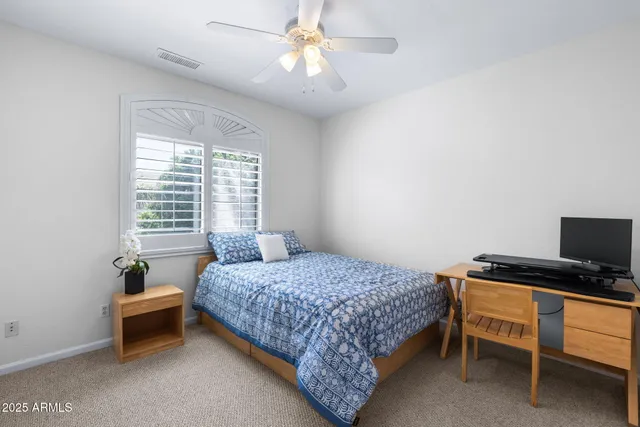 a spacious bedroom with a bed and a window