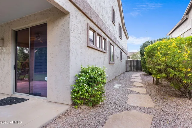 a view of a patio with chairs and floor to ceiling window