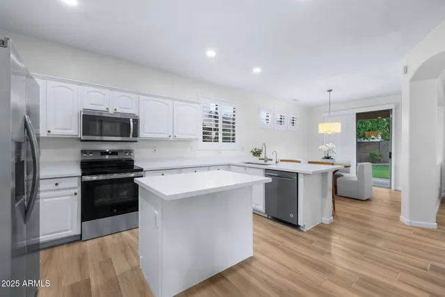 a kitchen with a sink stove and refrigerator