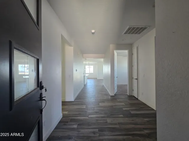 a view of hallway with wooden floor