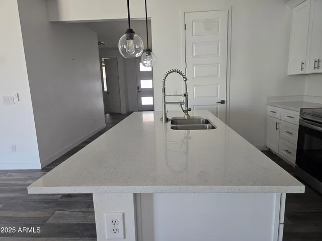 a close view of a sink a faucet and appliance in the kitchen