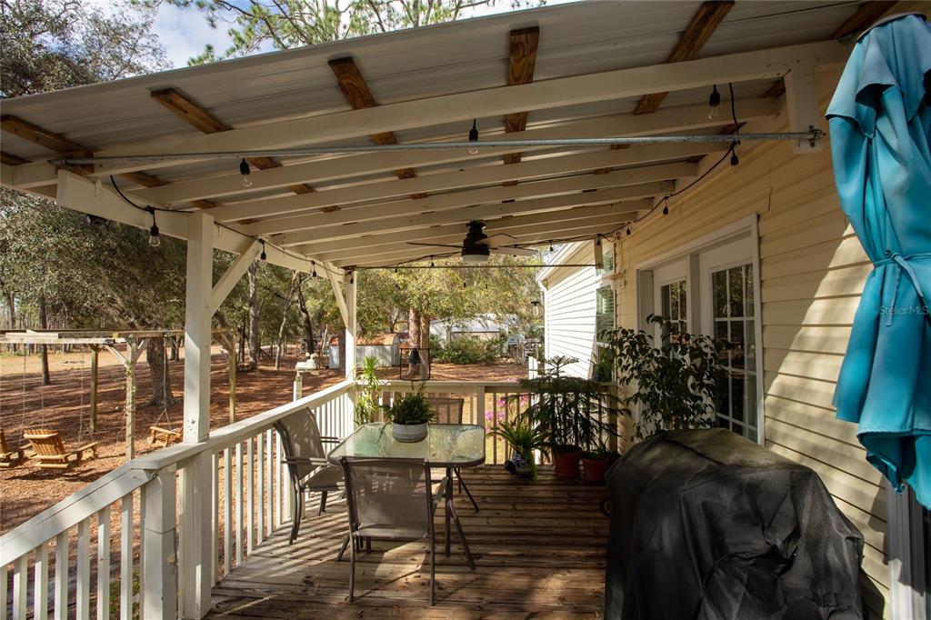 5711 Caribbean Circle Keystone Heights, FL 32656 - Photo 11 of 61 a view of a porch with chairs and couches