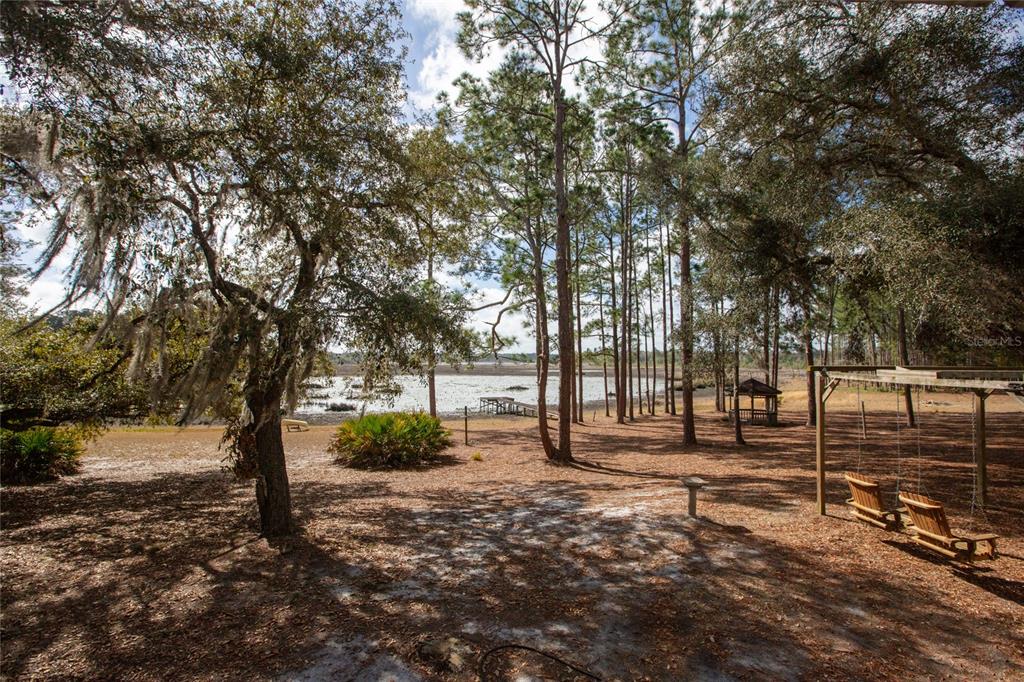 5711 Caribbean Circle Keystone Heights, FL 32656 - Photo 14 of 61 a backyard of a house with lots of green space
