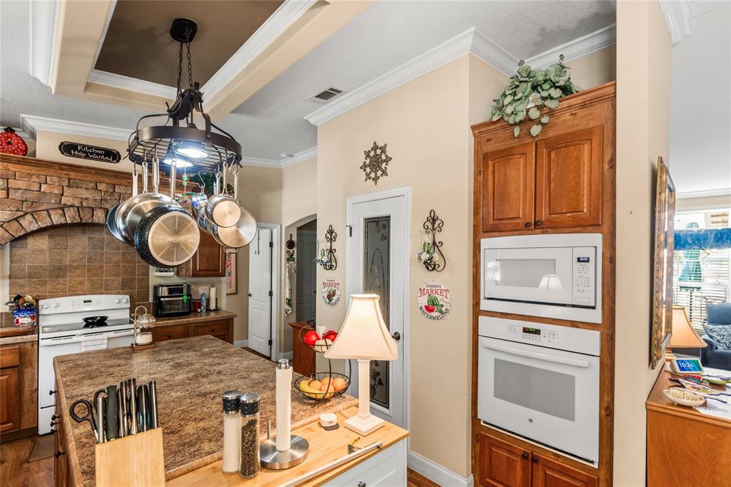 5711 Caribbean Circle Keystone Heights, FL 32656 - Photo 25 of 61 a kitchen with stainless steel appliances granite countertop a refrigerator and a stove