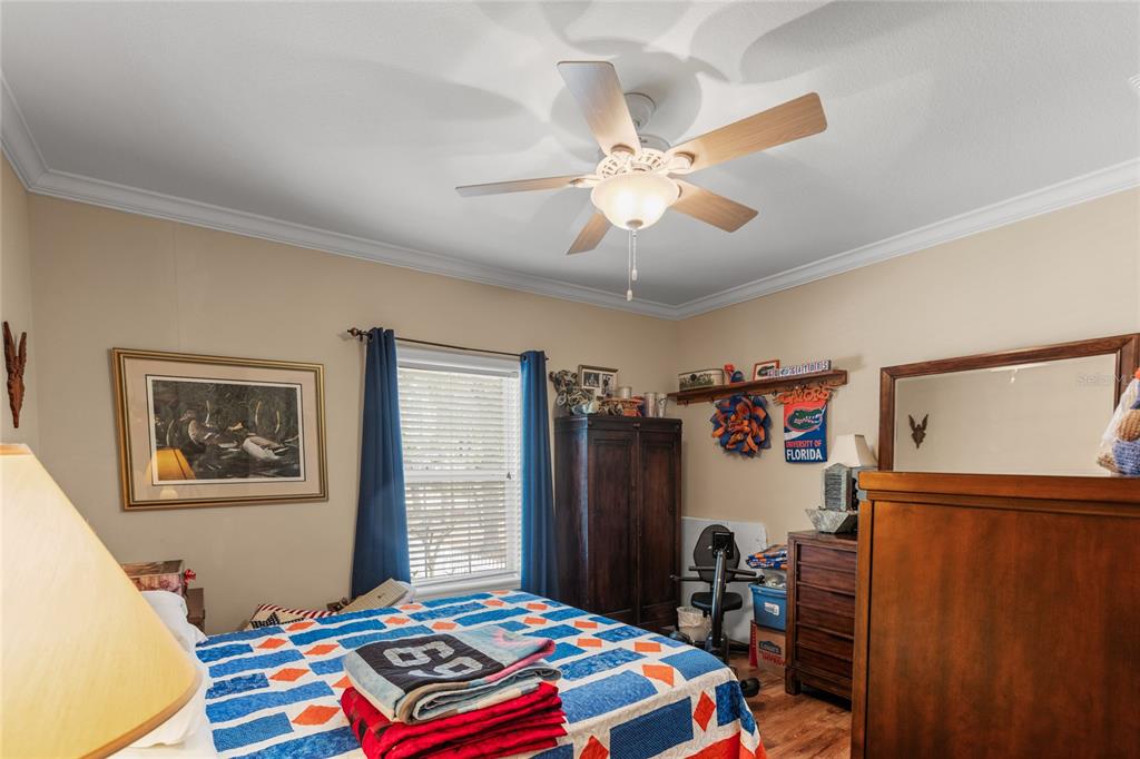 5711 Caribbean Circle Keystone Heights, FL 32656 - Photo 32 of 61 a bedroom with bed and a chandelier