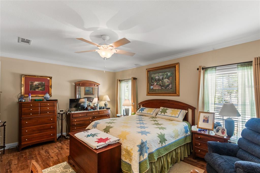 5711 Caribbean Circle Keystone Heights, FL 32656 - Photo 39 of 61 a bedroom with a bed a dresser next to a window