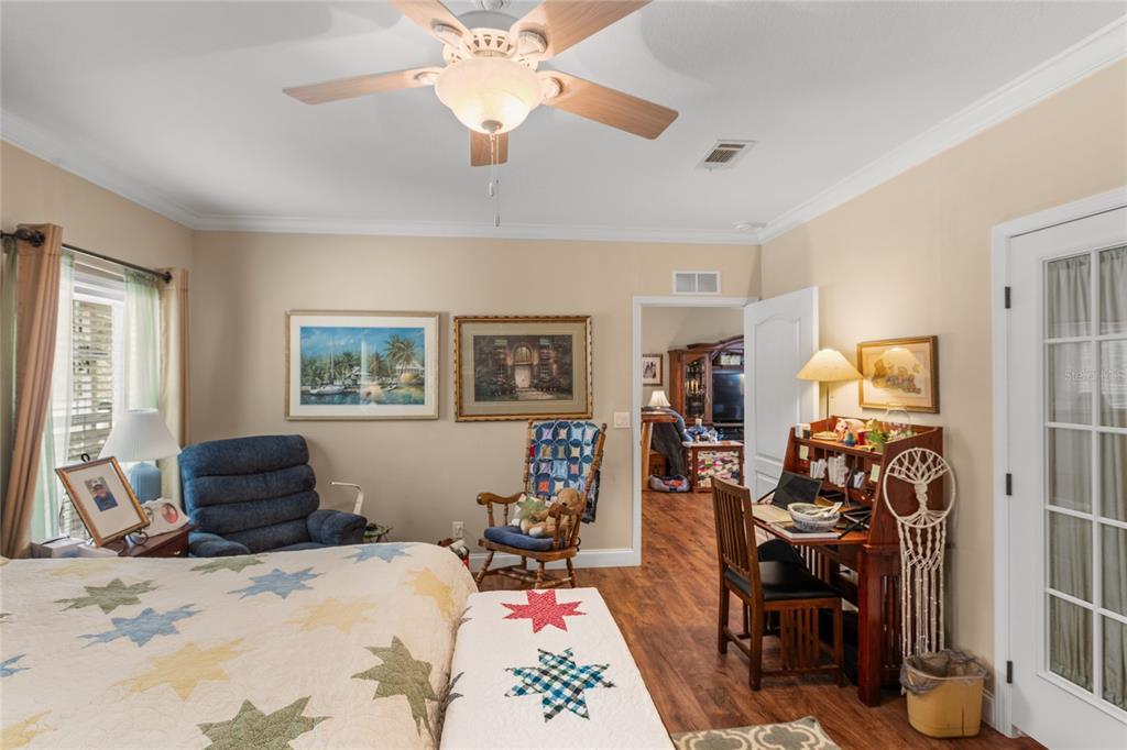 5711 Caribbean Circle Keystone Heights, FL 32656 - Photo 47 of 61 a bedroom with a bed and wooden floor