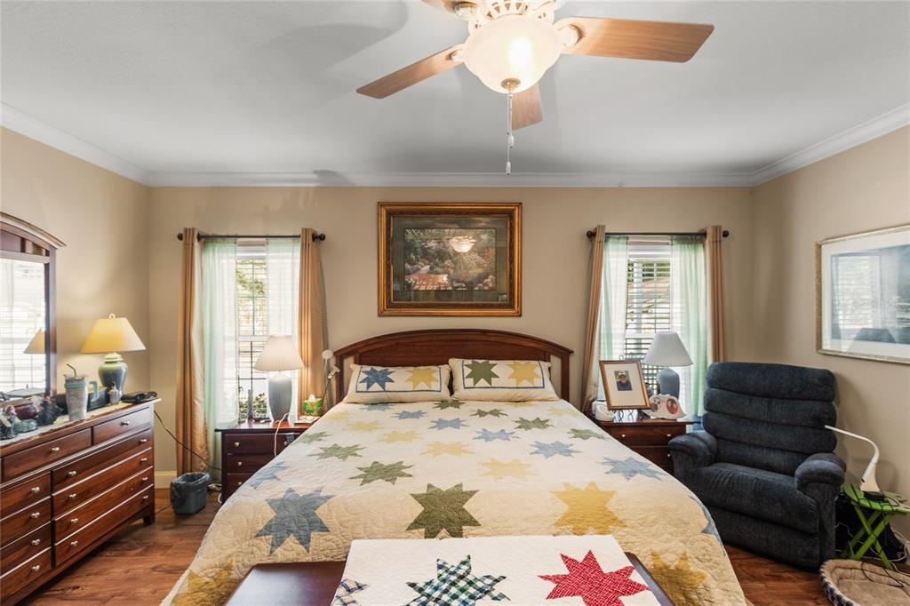5711 Caribbean Circle Keystone Heights, FL 32656 - Photo 48 of 61 a bedroom with a bed and wooden floor