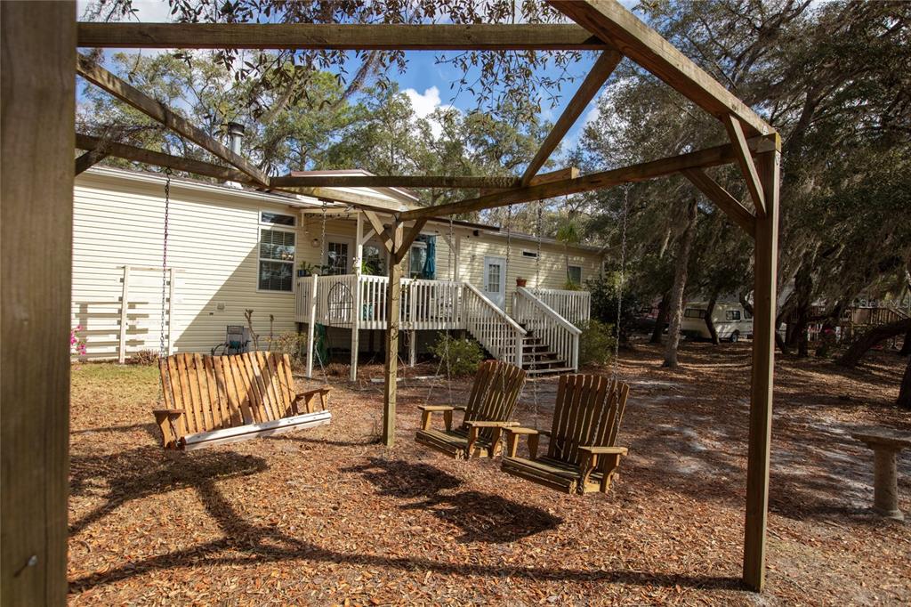 5711 Caribbean Circle Keystone Heights, FL 32656 - Photo 59 of 61 a view of a backyard with a wooden deck