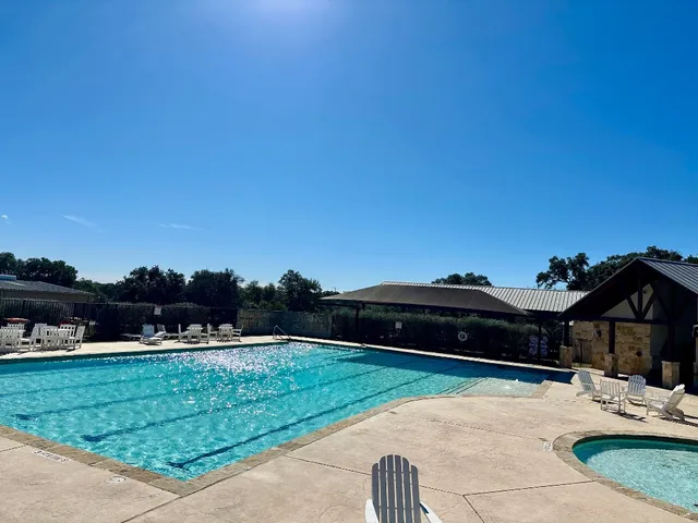 a view of outdoor space with swimming pool and green space